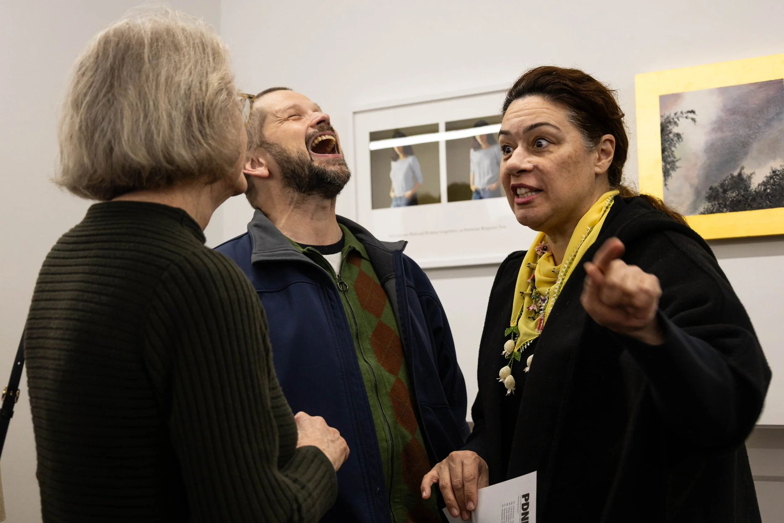 A Lively Conversation - At the Photographs Do Not Bend Gallery, featured artist and UNT Photography professor Dornith Doherty discusses her piece with UNT Metalsmithing and Jewelry professor James Thurman and his wife, fellow jewelry maker Umut Thurm