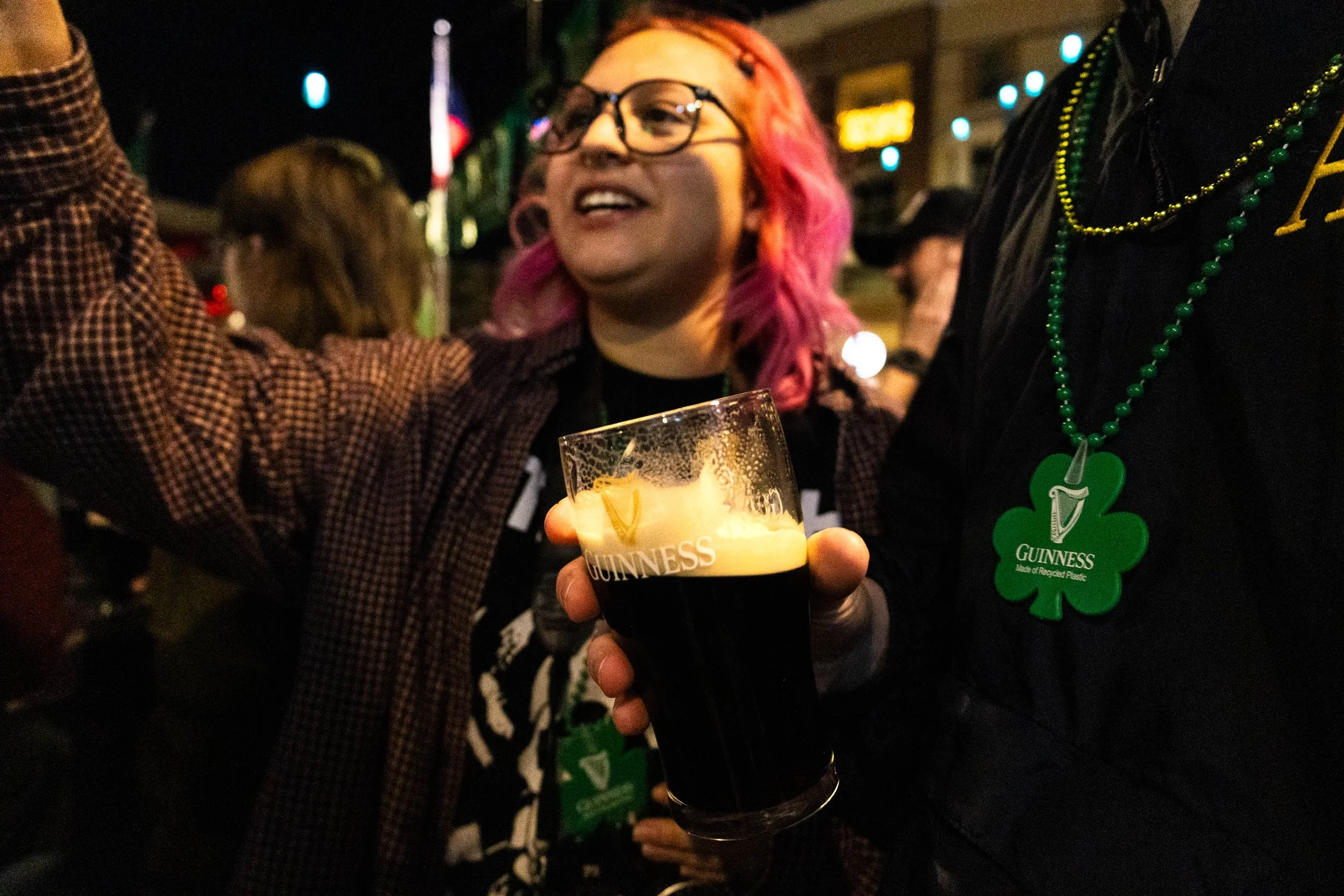 Denton resident and UNT student Itzel Hernandez shares a toast with friends at Lucky Lou's St. Patrick's Day Pint Night event. Starting at 9 pm, the bar sold pints of Guinness in specialty-themed glasses for the holiday.