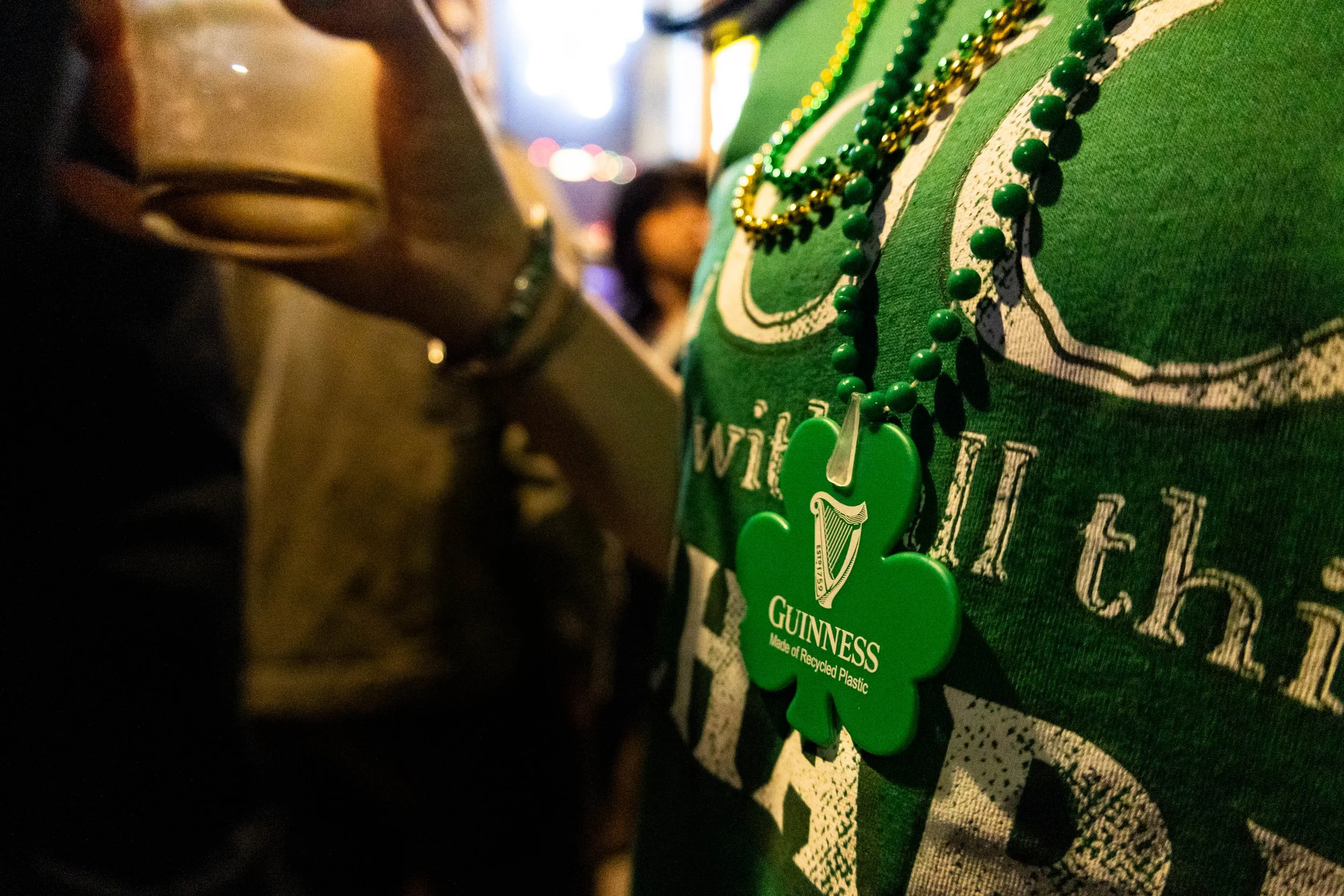 For their St. Patrick's Day event, Lucky Lou's bar gave out free green bead necklaces at the entrance. The Guinness logo was a signal to the themed pint glass of the evening.