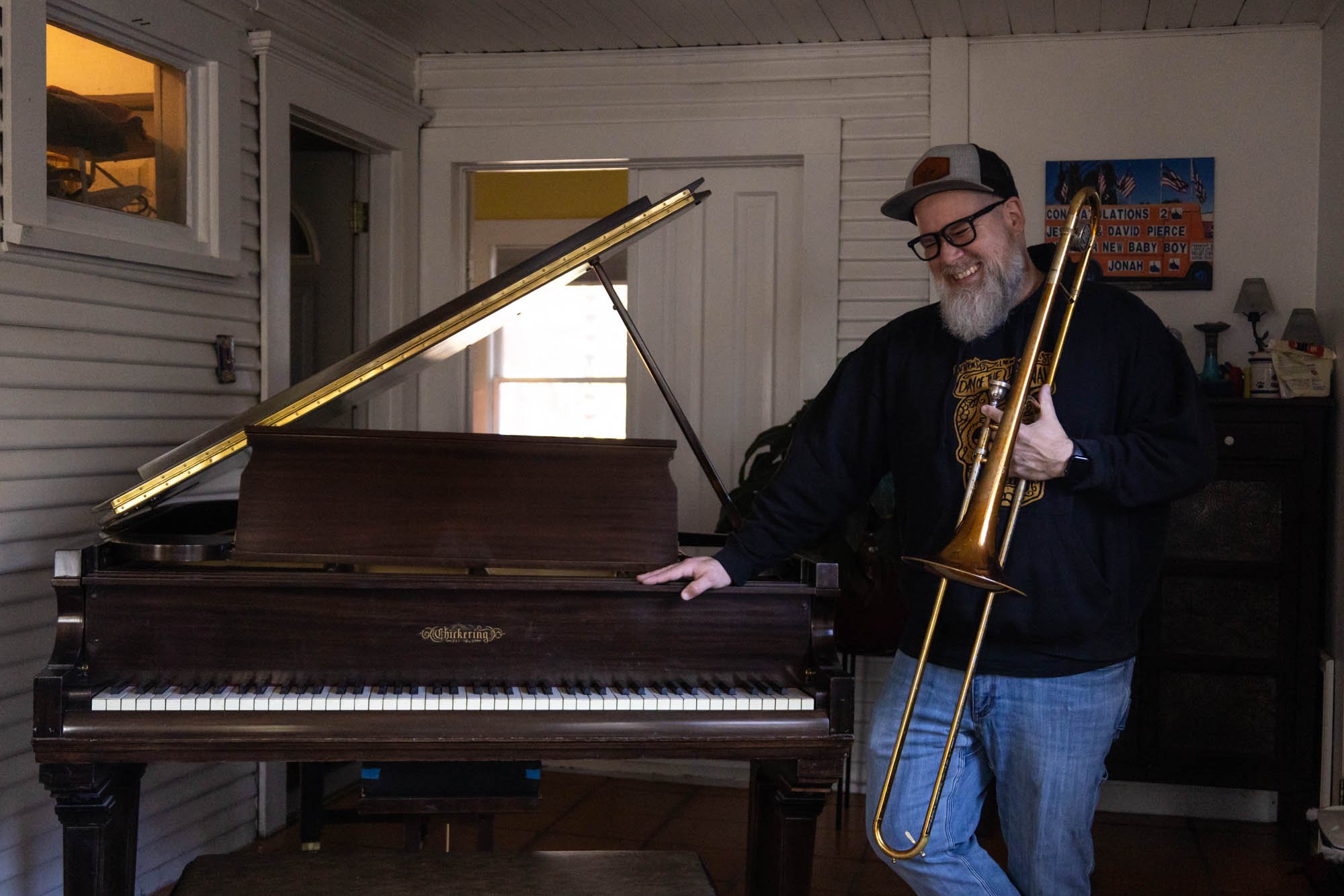 While attempting to pose for a portrait, David Pierce laughs at his two dogs trying to knock the photographer over. He joked that Mabel, his Yorkie, was trying to ruin his photo.