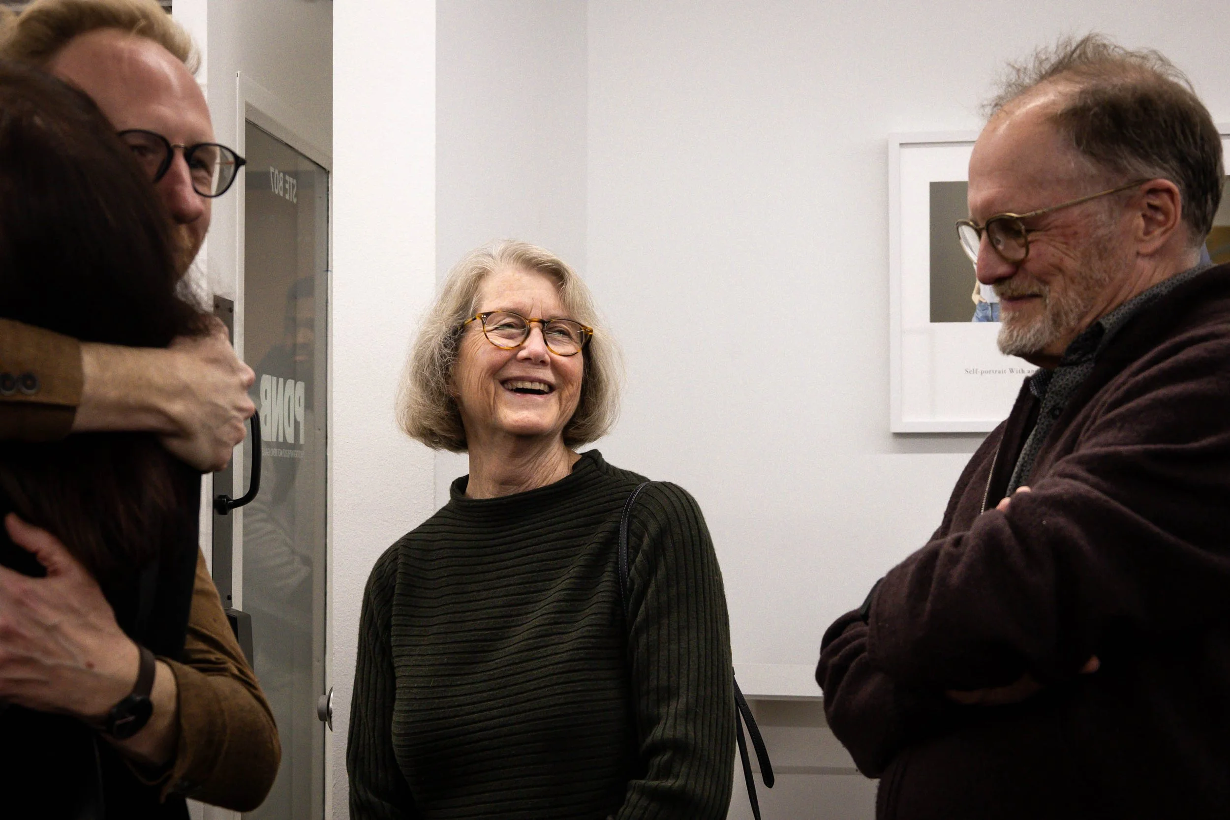 Bit of Humor - At the PDNB Gallery's Texas Women Artists show, featured artist and UNT professor Dornith Doherty laughs alongside her husband as their conversation is interrupted. Doherty has won multiple awards for her work, including the UNT Eminen