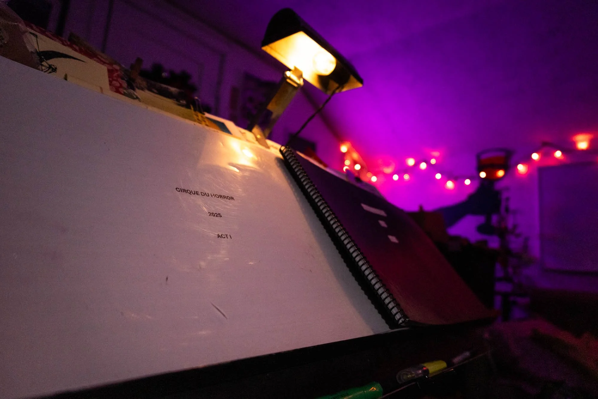 On the music stand in David Pierce's studio sits the sheet music from the 2025 Cirque du Horror Halloween musical. The lighting in the room was kept dim for ambiance, according to Pierce.