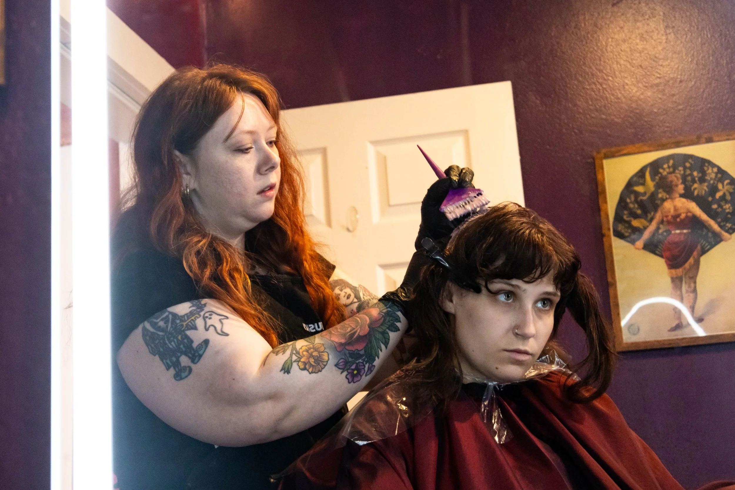 2nd year stylist Libby Choate applies Pravana permanent vivid dye on her client's roots at Neon Seance Salon. The final product would be a ghost root that fades into a deep brown.