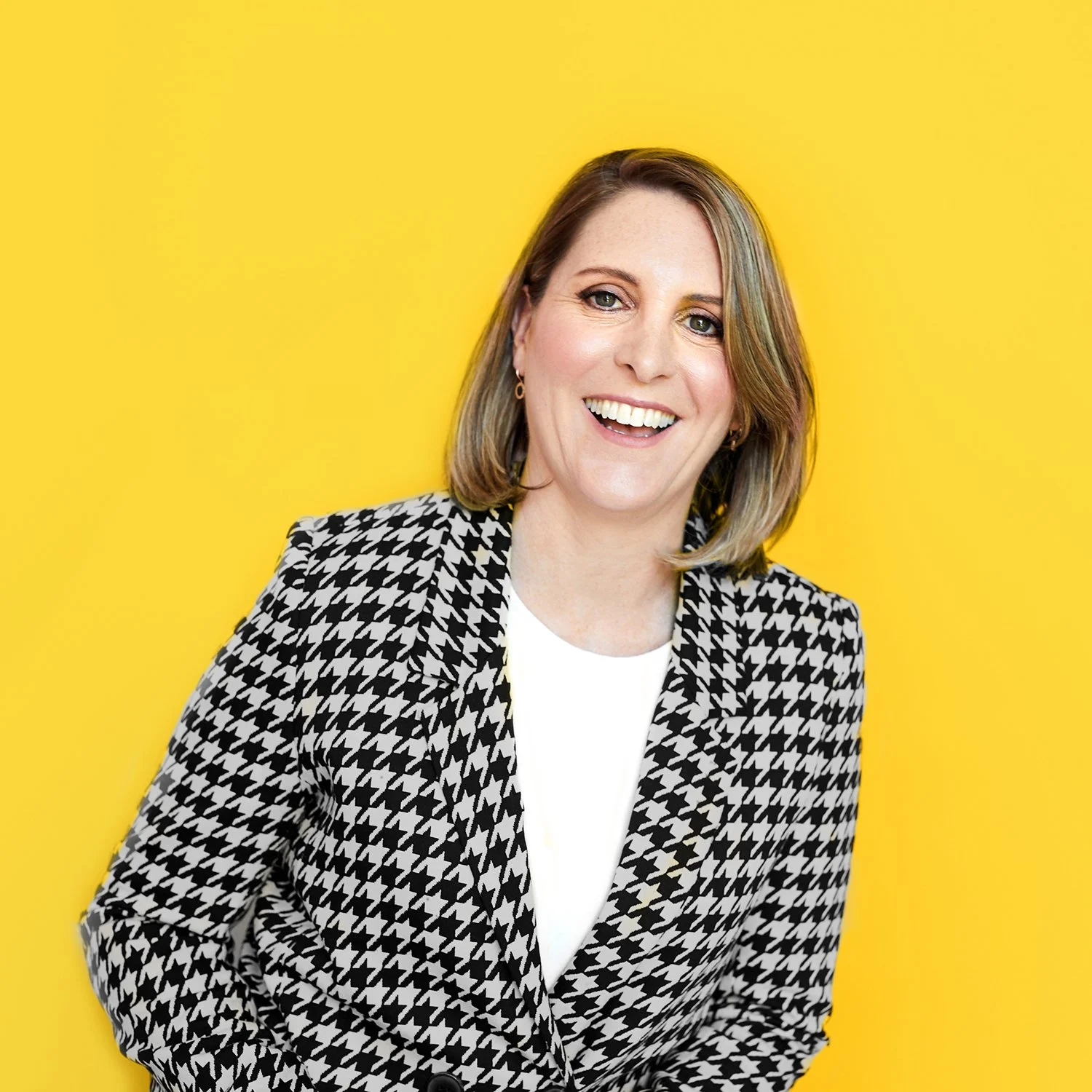 Fiona Wilhelm, AI in Action founder, profile image on a yellow background.