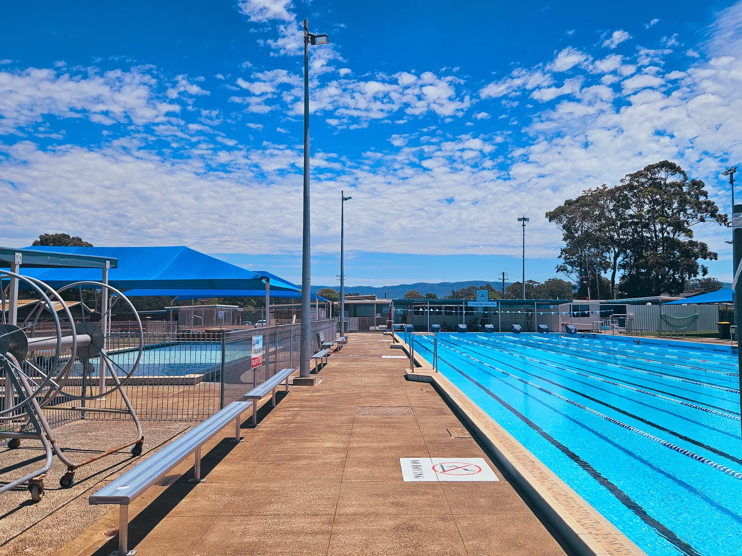 Oak Flats 50m Pool. If you're looking to crash out a few Kms then Oak Flats is the nearest 50m Pool. It's either super-busy (with parties) or empty. Budget for a 15 minute drive to get there. Free parking.