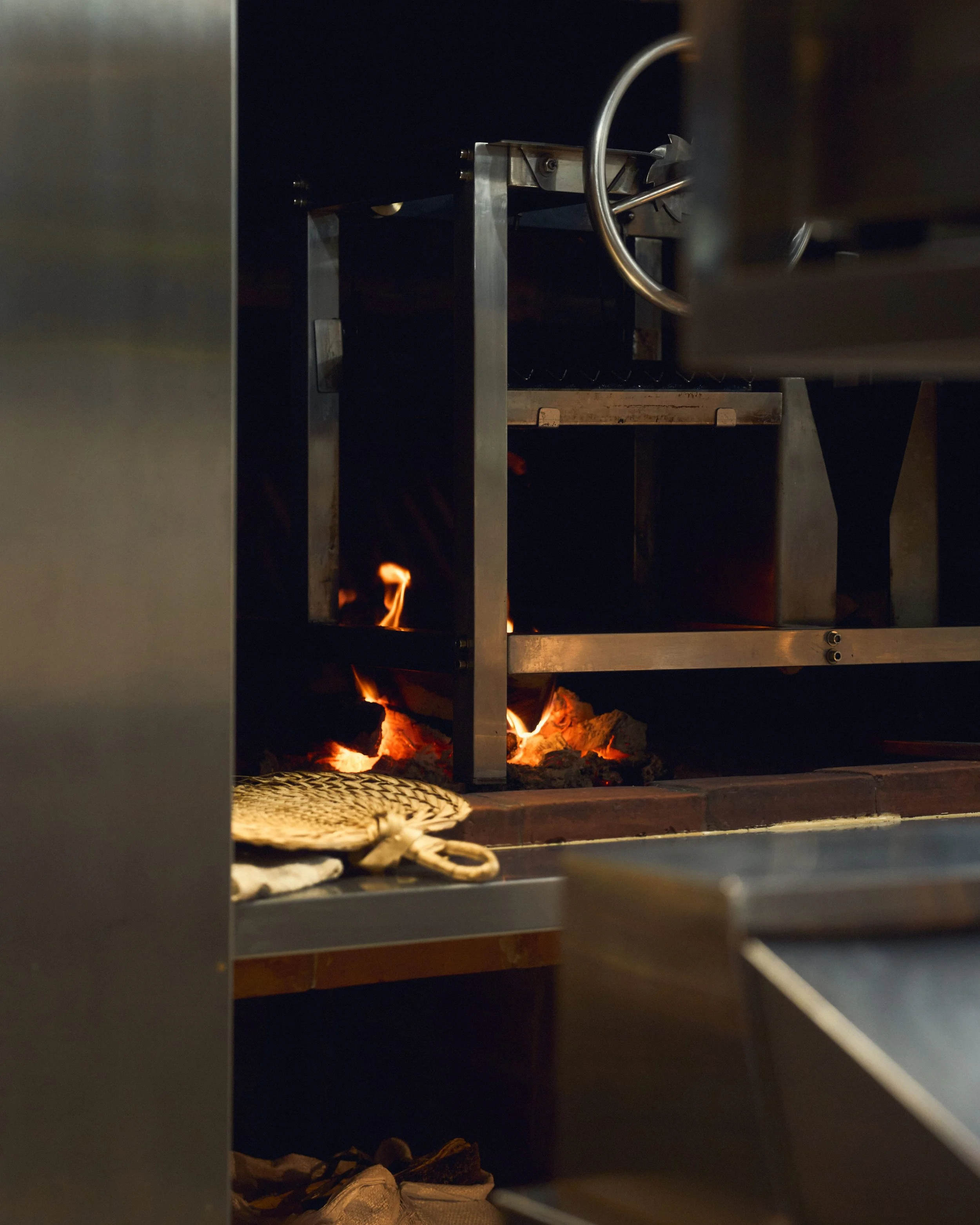a wooden fire cook place in restaurant idalia