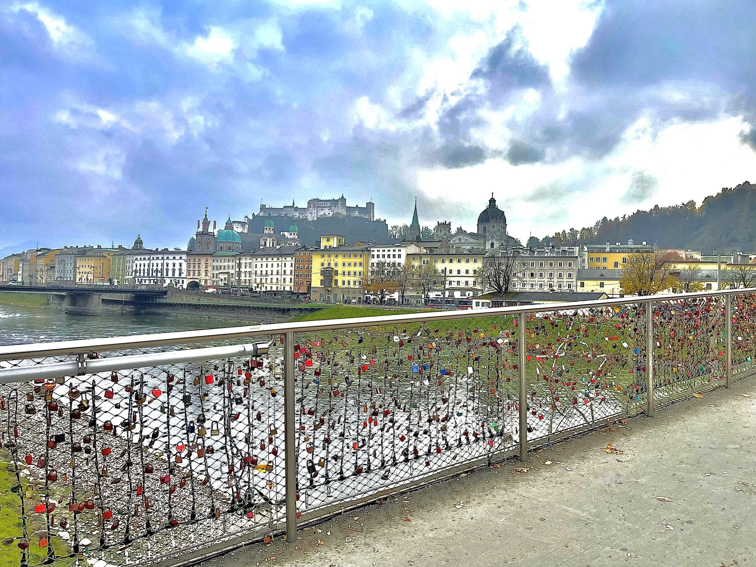 Cityscape of Salzburg, Austria, taken near Hotel Sacher Salzburg on the Marko-Feingold-Steg Bridge with a view of Fortress Hohensalzburg.