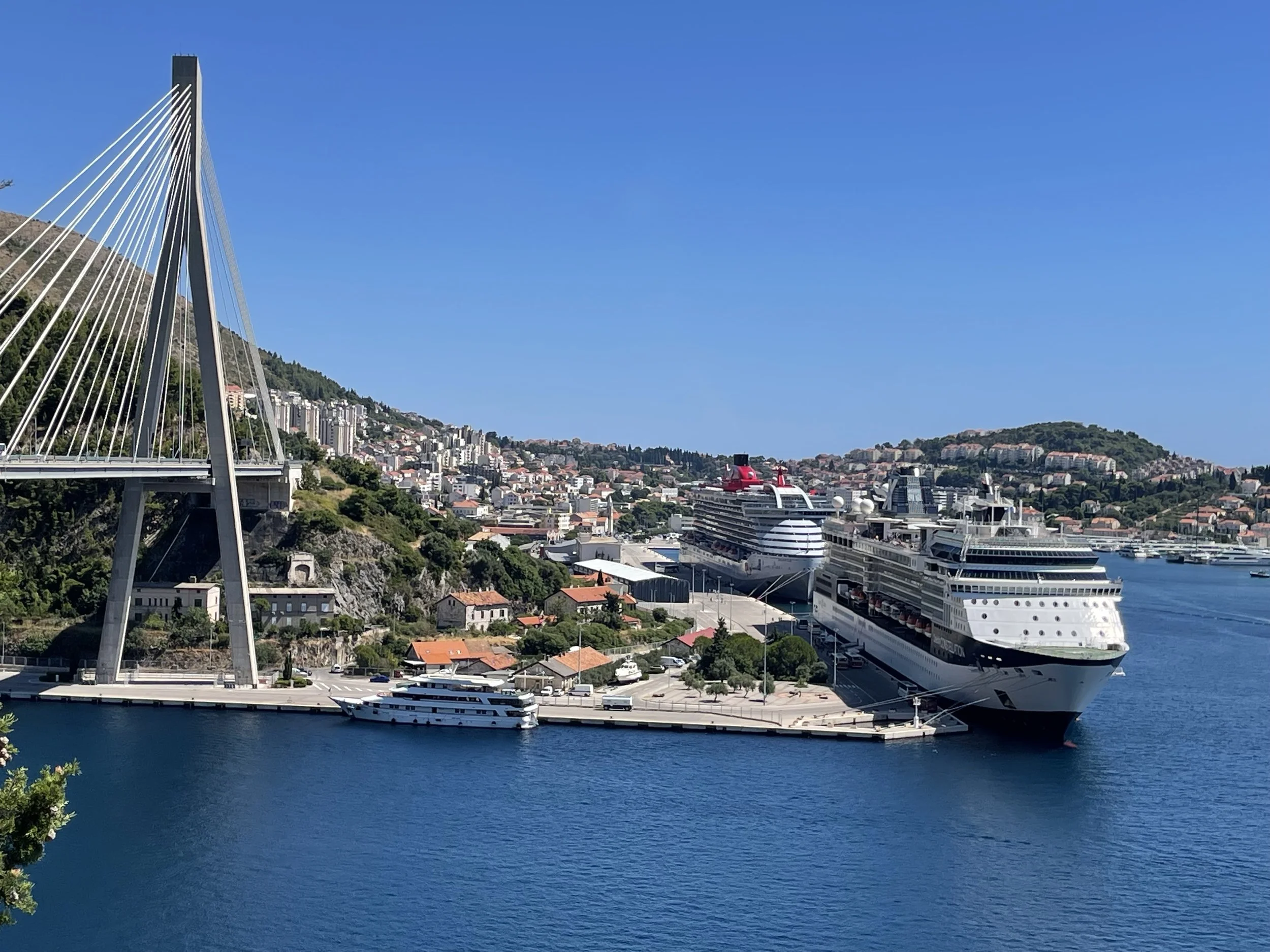 Virgin Voyages Resilient Lady and Celebrity Cruises ship docked at Port of Dubrovnik next to Dr. Franjo Tudman Bridge in Dubrovnik, Croatia.
