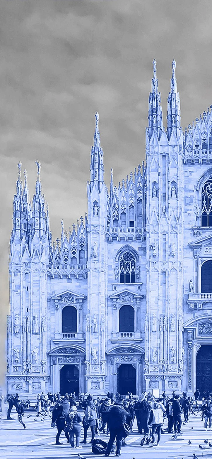 People walking and pigeons in front of Milan Cathedral with its gothic spires in Milan, Italy.