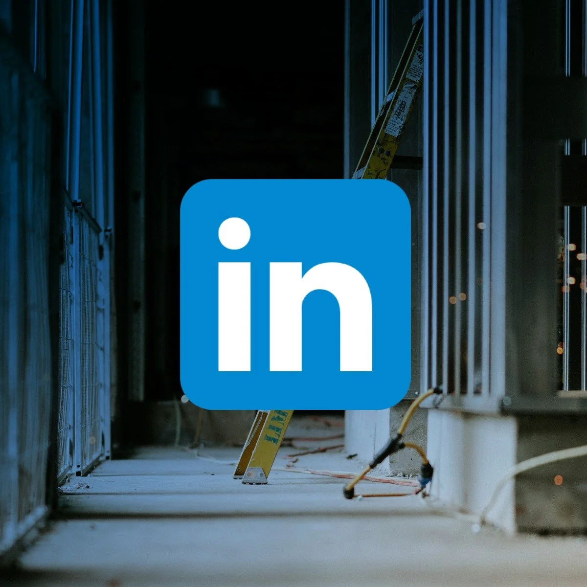 Interior view of a construction site under renovation featuring scaffolding and metal frames with a LinkedIn logo overlay.