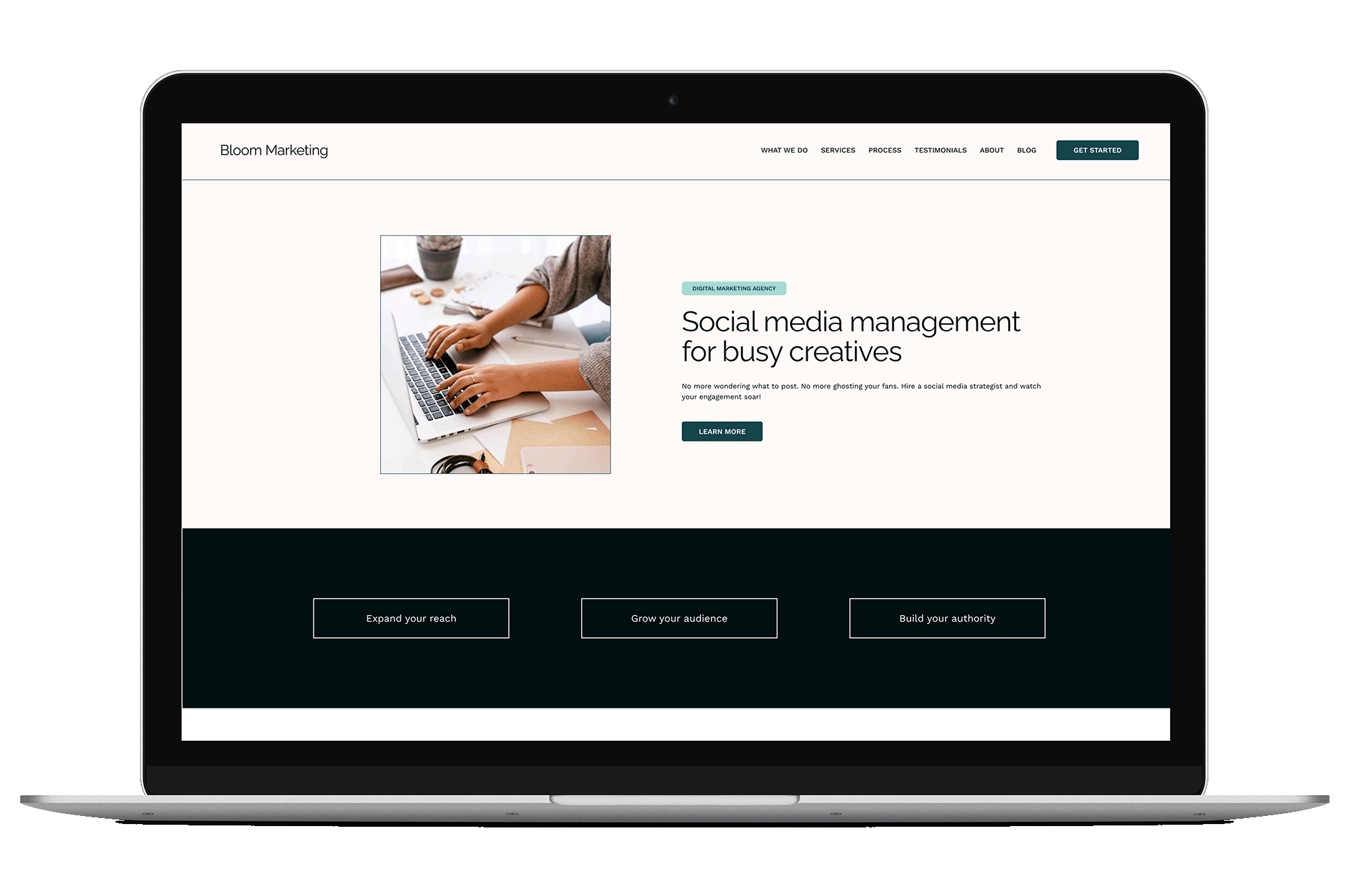 Laptop displaying a website for Bloom Marketing with a section about social media management for busy creatives, featuring a photo of hands typing on a laptop keyboard, with navigation menu and call-to-action buttons.
