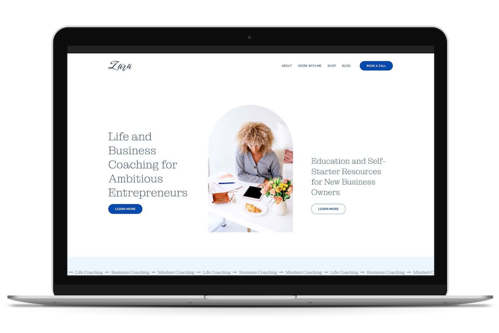 Screenshot of a website homepage for Zara offering life and business coaching for entrepreneurs, with a photo of a woman working at a desk, and navigation links including 'About', 'Work with Me', 'Shop', 'Blog', and a call-to-action button for booking a call.
