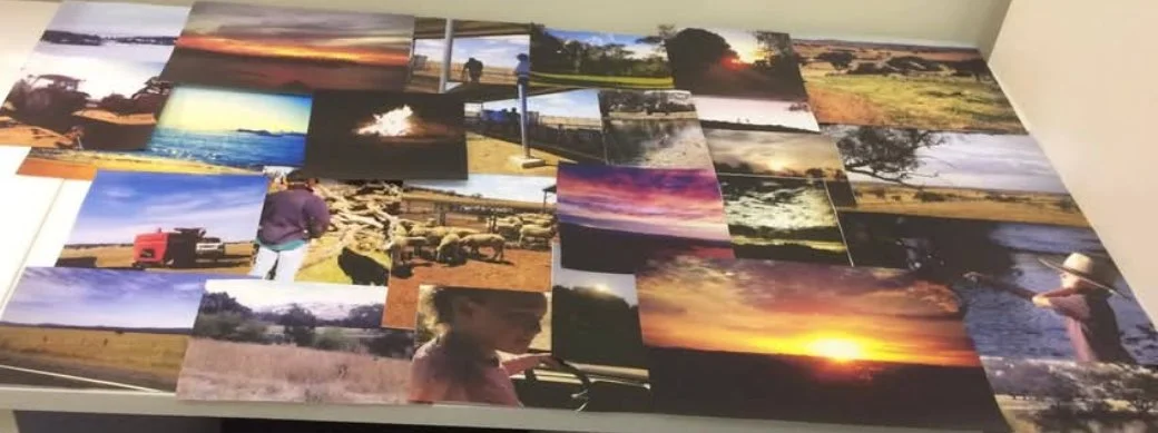Collection of various landscape and outdoor photography prints laid out on a table.