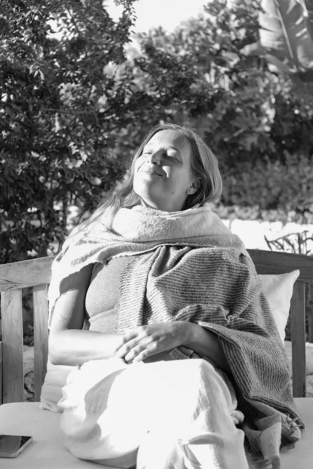 woman sitting in chair face in the sun