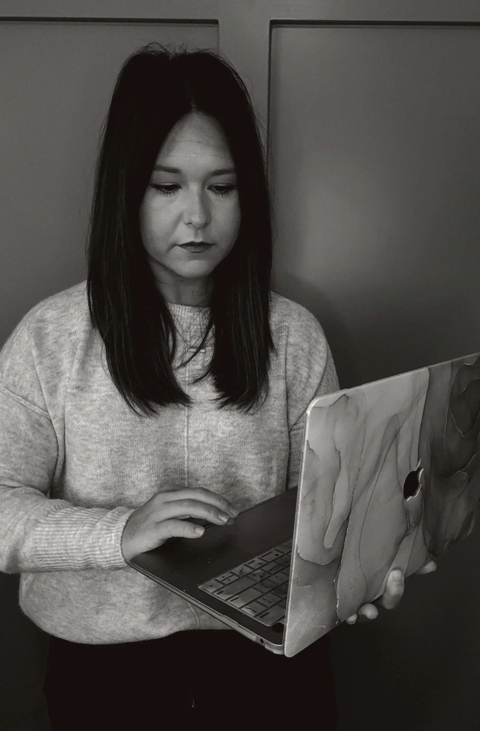 Black and white image of Moxie Founder typing on laptop