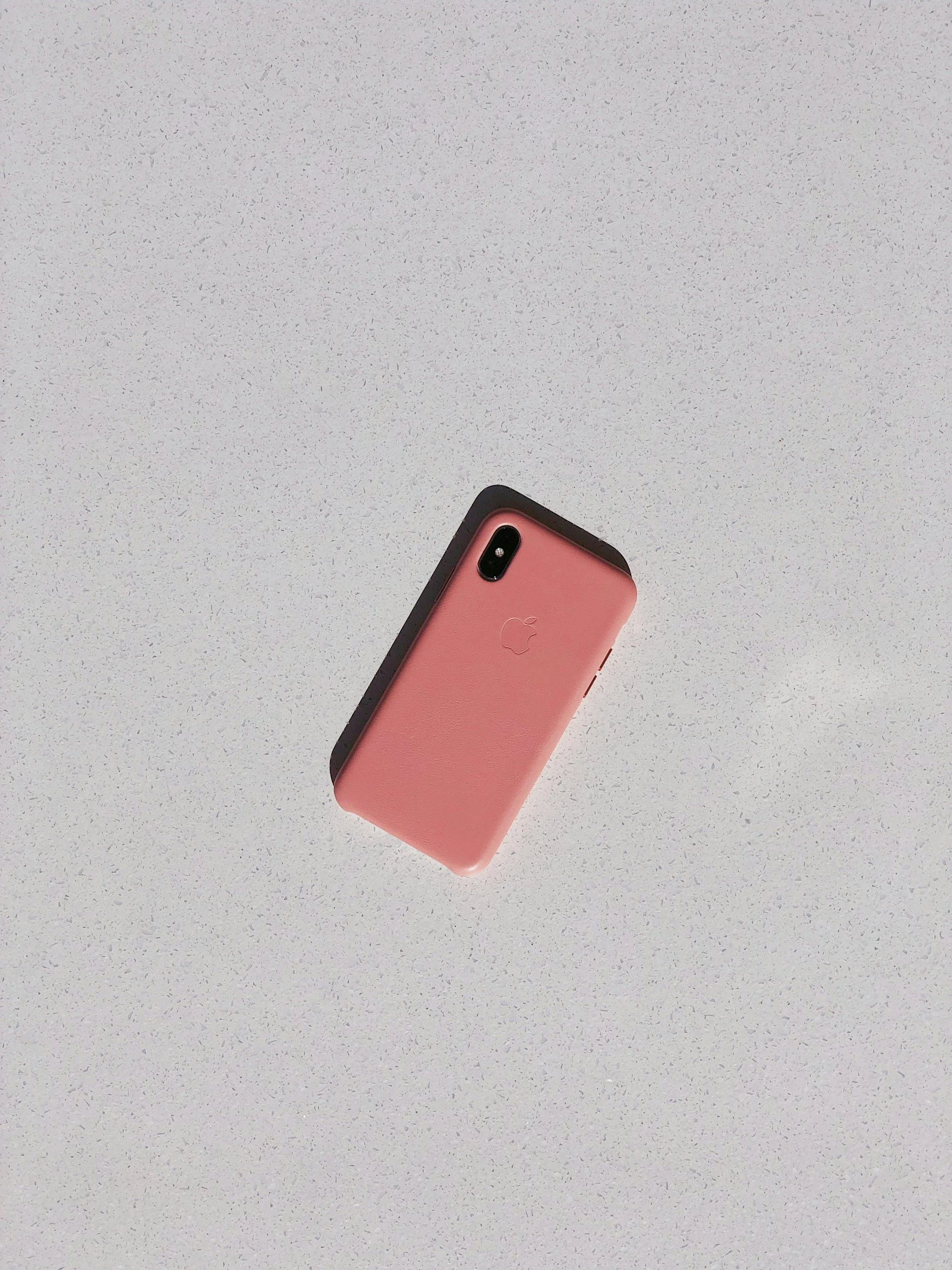 Coral iPhone on grey countertop