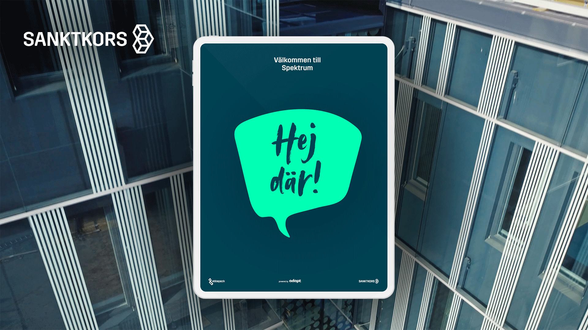 A large digital screen displays a Swedish message saying "Hej där!" in a speech bubble, with a modern building with glass windows reflecting the sky in the background.