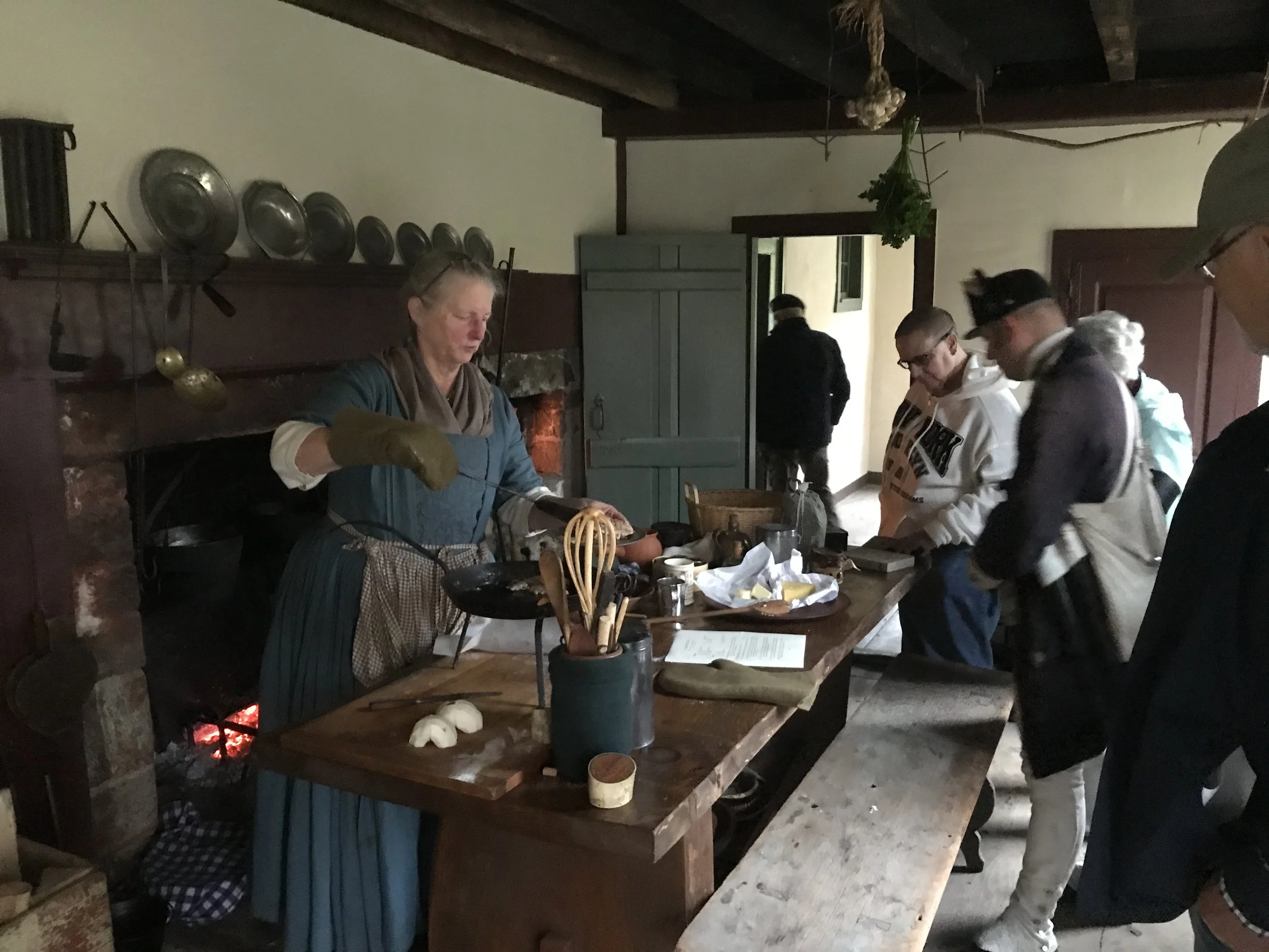 Becky Hendricks demonstrating hearth cooking in the Huntington Homestead's lean-to kitchen .