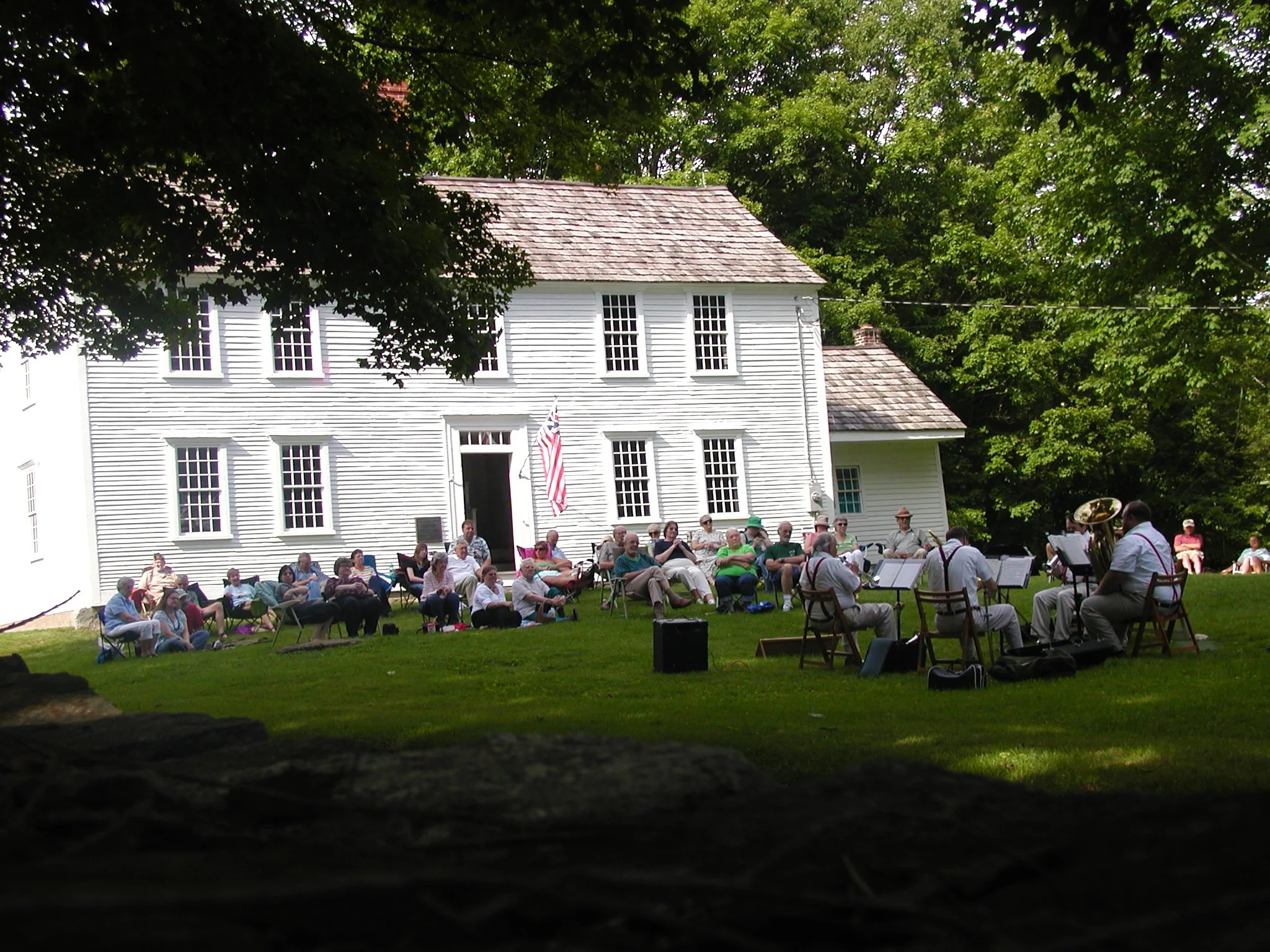 A group of brass band enthusiasts enjoying an evening concert at the birthplace of Declaration of Independence signer Samuel Huntington..