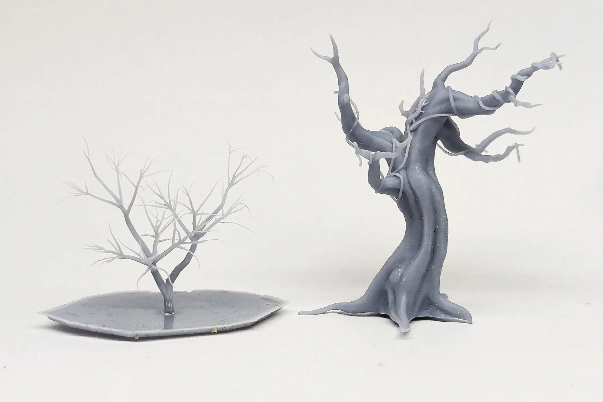 a pair of 3D printed trees, ready for paint and application of texture by our bespoke tree department