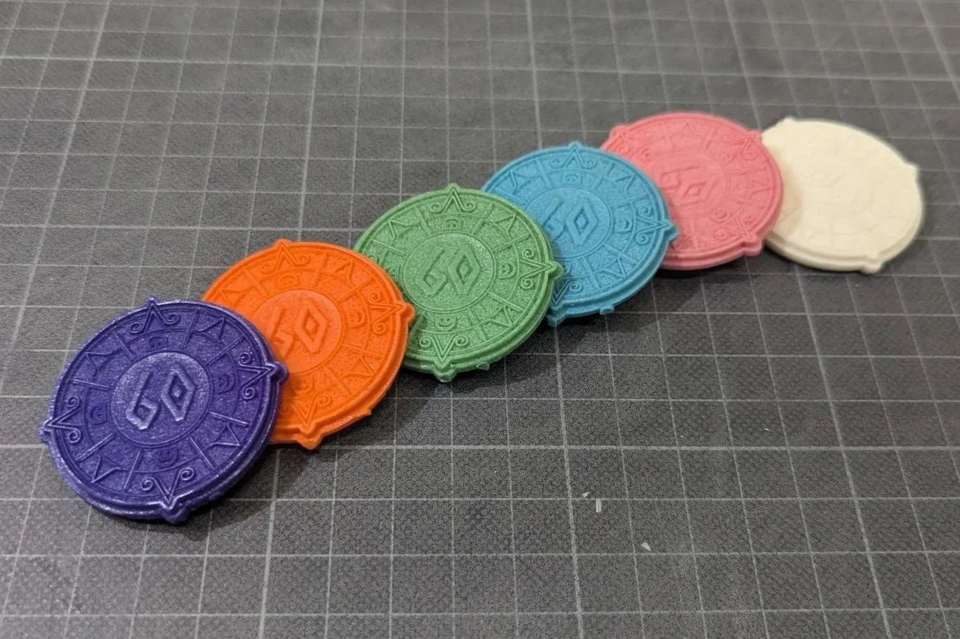 colourful resin casts of our Arch 60 sample coin