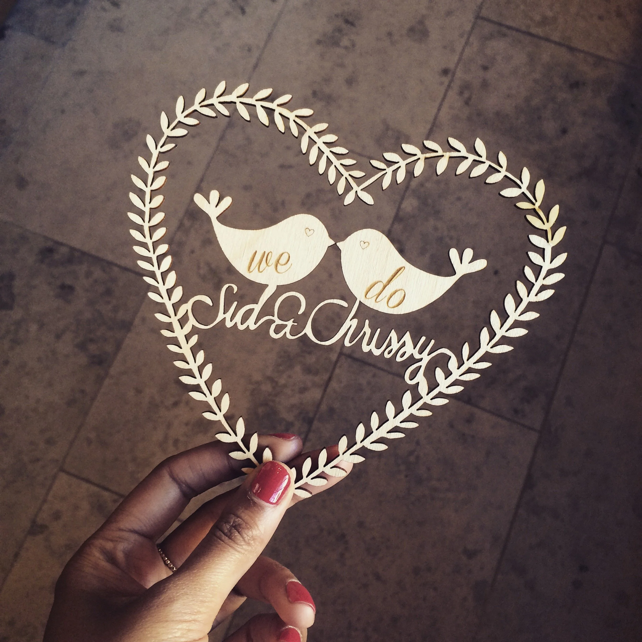 a laser cut topper in plywood for a wedding cake