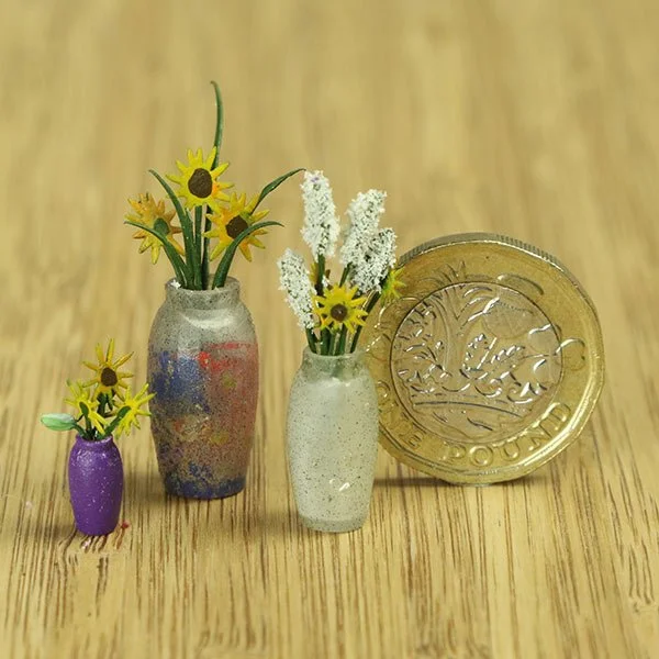 a scale model of a few vases of flowers