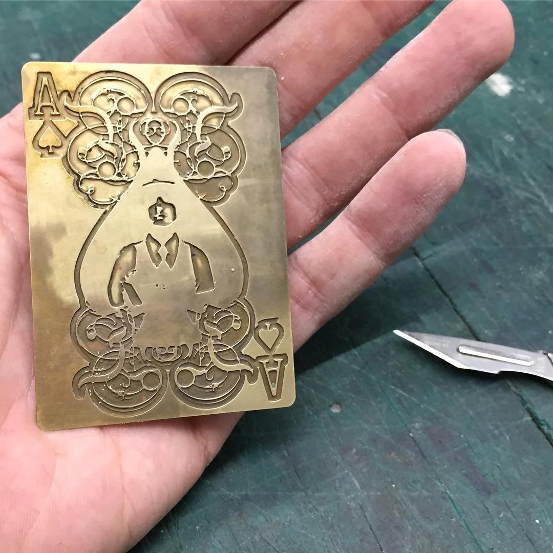 An aged brass Ace playing card, photoetched.