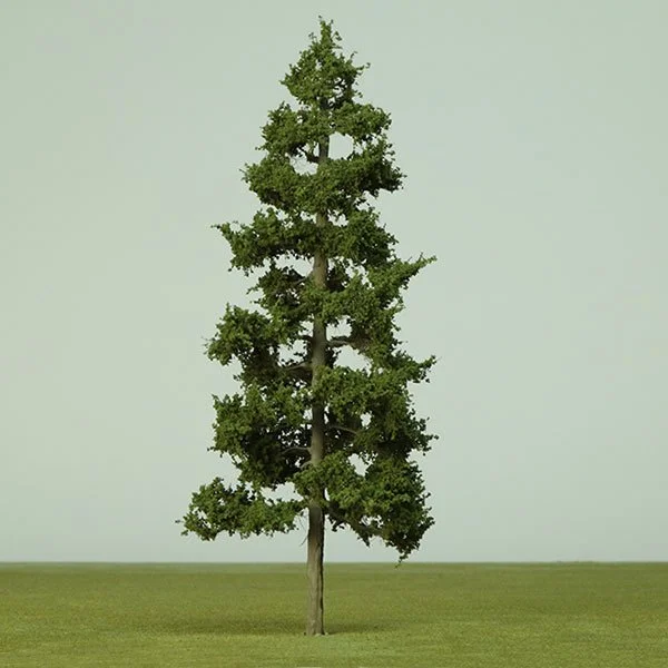 A model pine tree with sparse branches standing alone on a grassy field against a pale sky.