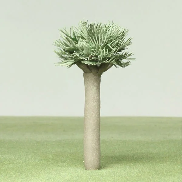A model tree with a thick trunk and a rounded, spiky top resembling a cactus, set on a green surface with a plain light background.