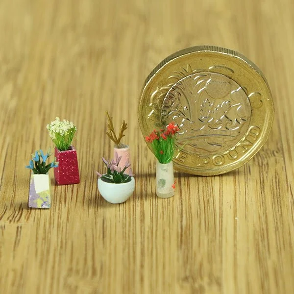 a scale model of a few vases of flowers