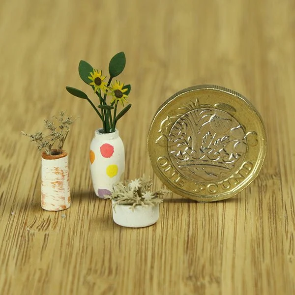 a scale model of a few vases of flowers