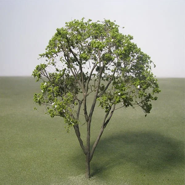 A model crape myrtle tree with green leaves on a small grassy surface