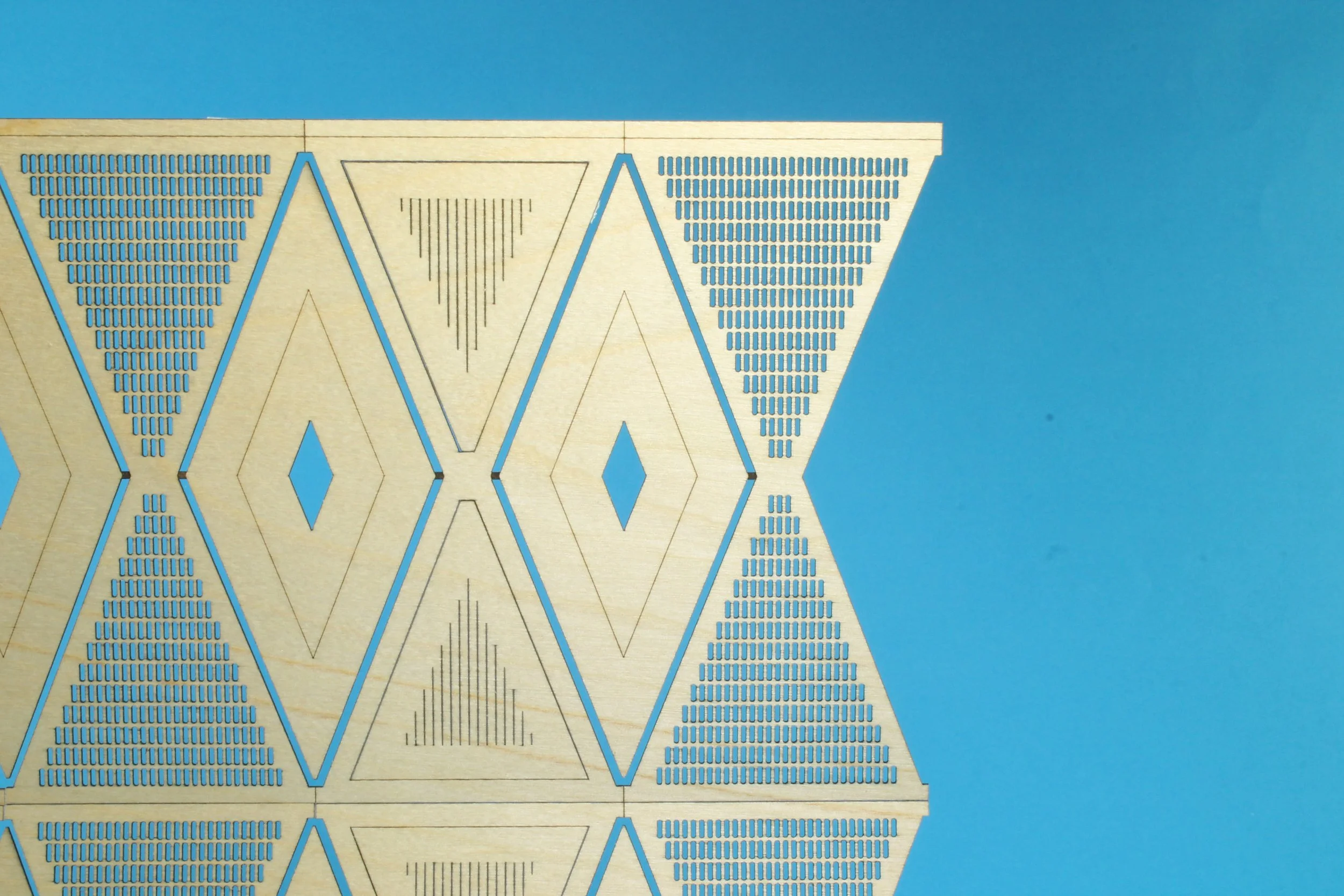 lasercut geometric shapes in thin plywood. 