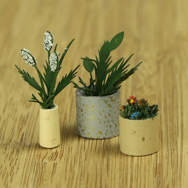 a scale model of a few vases of flowers
