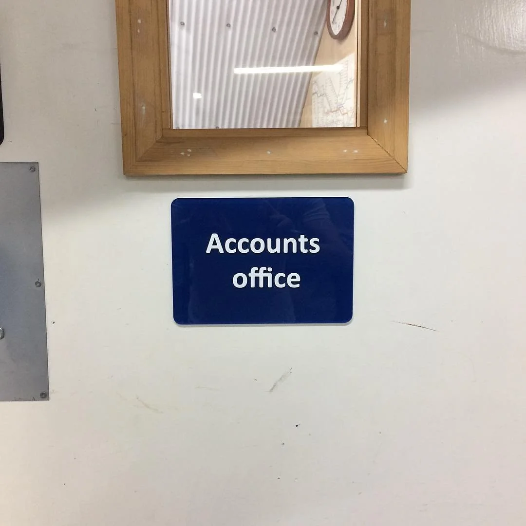 A vinyl cut sign on a laser cut acrylic plate.