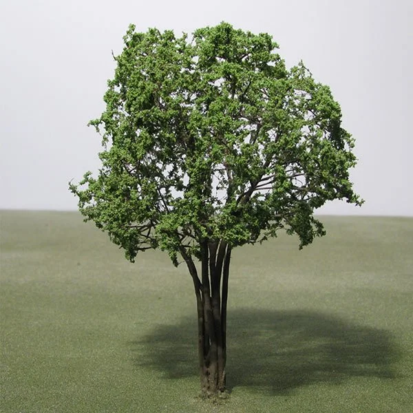 A green leafy model tree on a grassy field with no other objects visible.