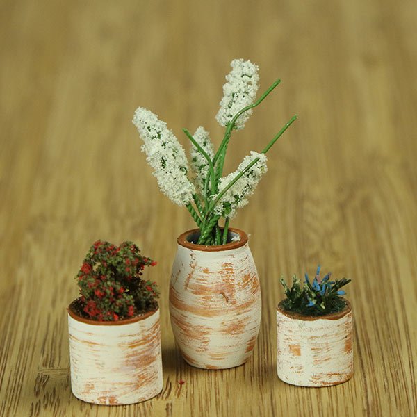 a scale model of a few vases of flowers