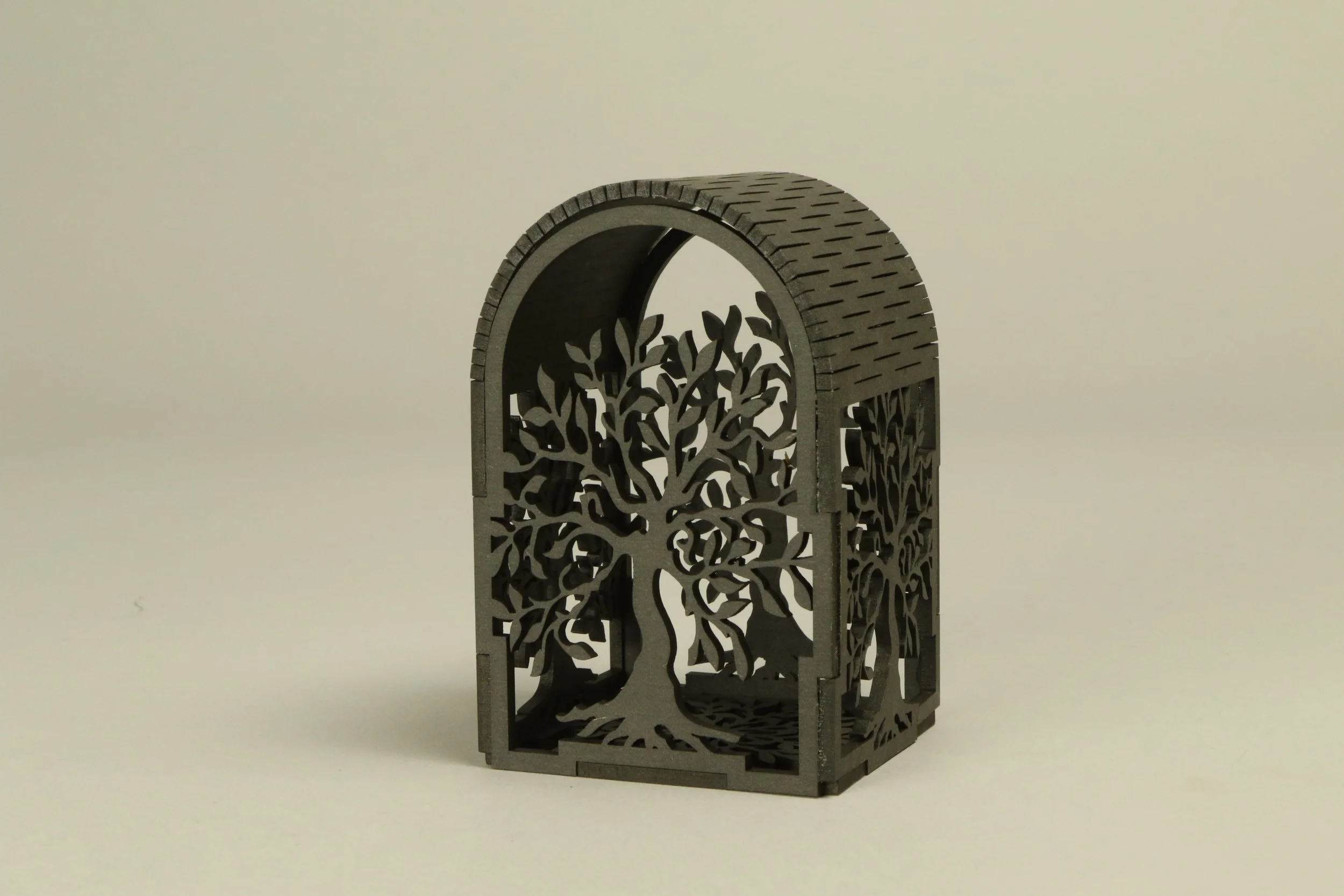 a decorative tealight holder, laser cut in black mdf