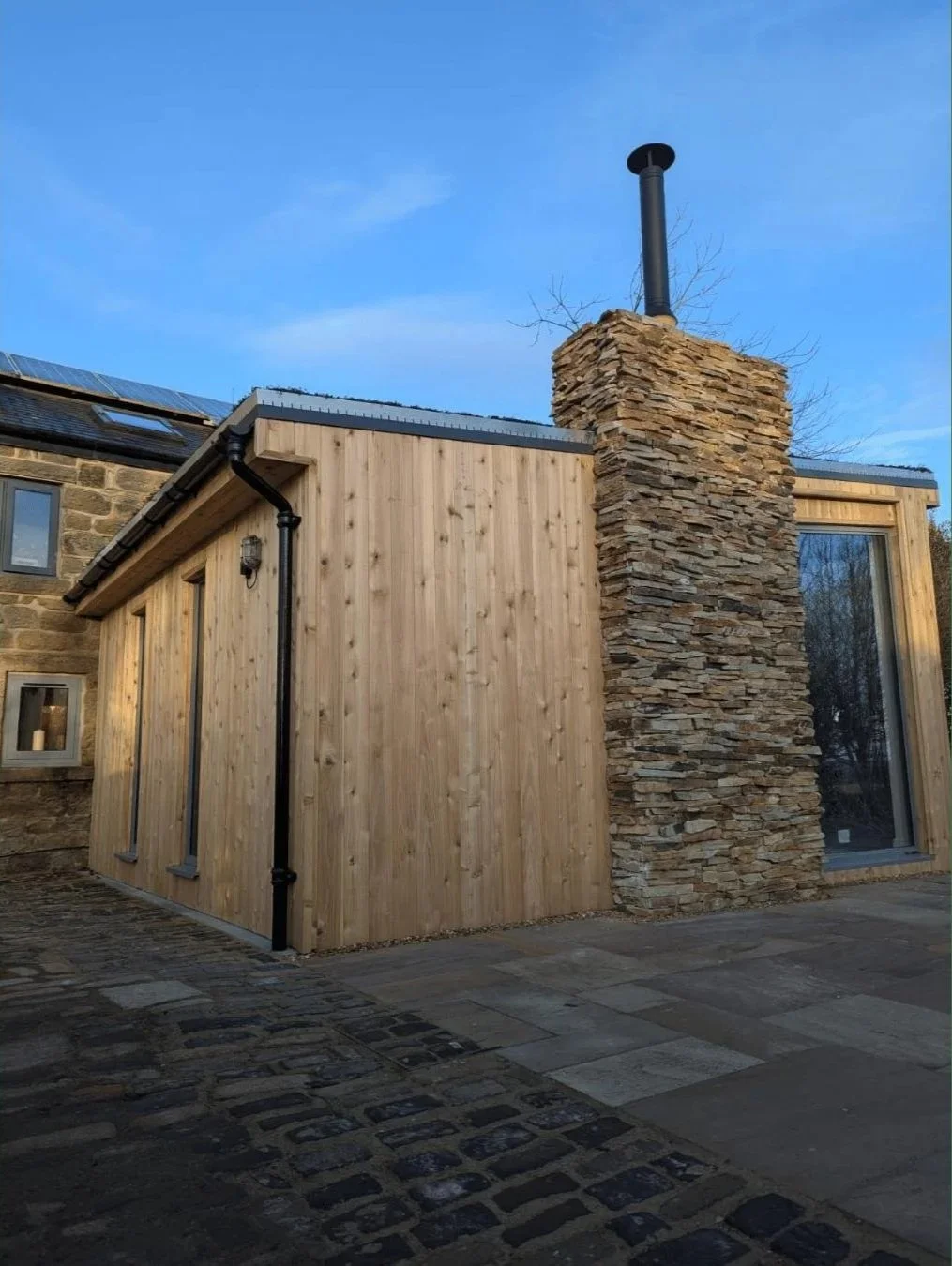 Outdoor living space - wooden construction with stone chimney breast