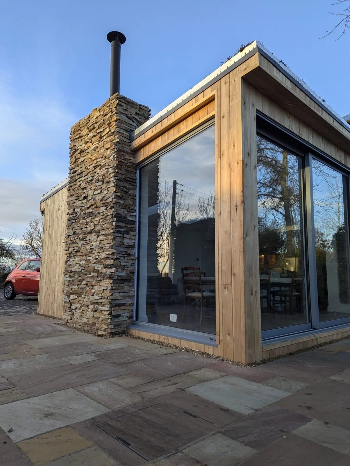 Outdoor living space - wooden construction with stone chimney breast
