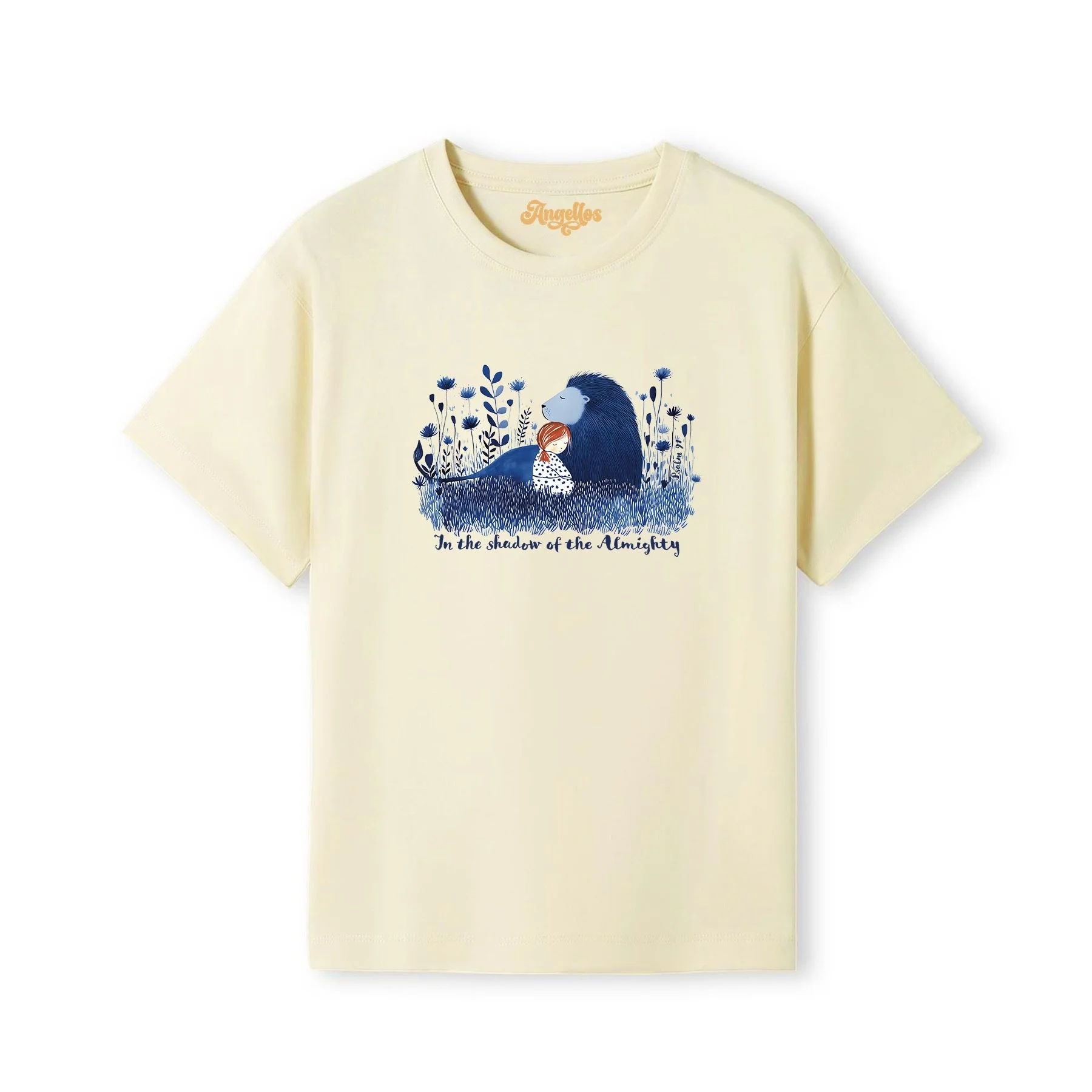 A blonde girl wearing a Christian t-shirt in natural color, with a picture of a blue lion and girl, with the words 'In the Shadow of the Almighty'