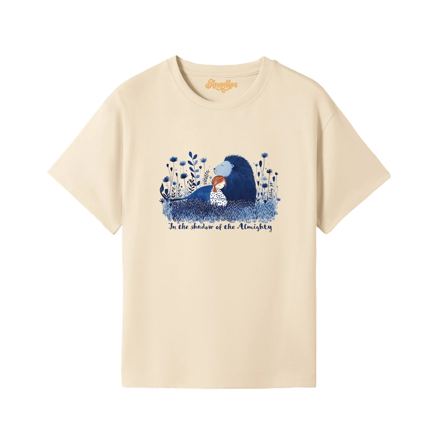 A blonde girl wearing a Christian t-shirt in cream color, with a picture of a blue lion and girl, with the words 'In the Shadow of the Almighty'