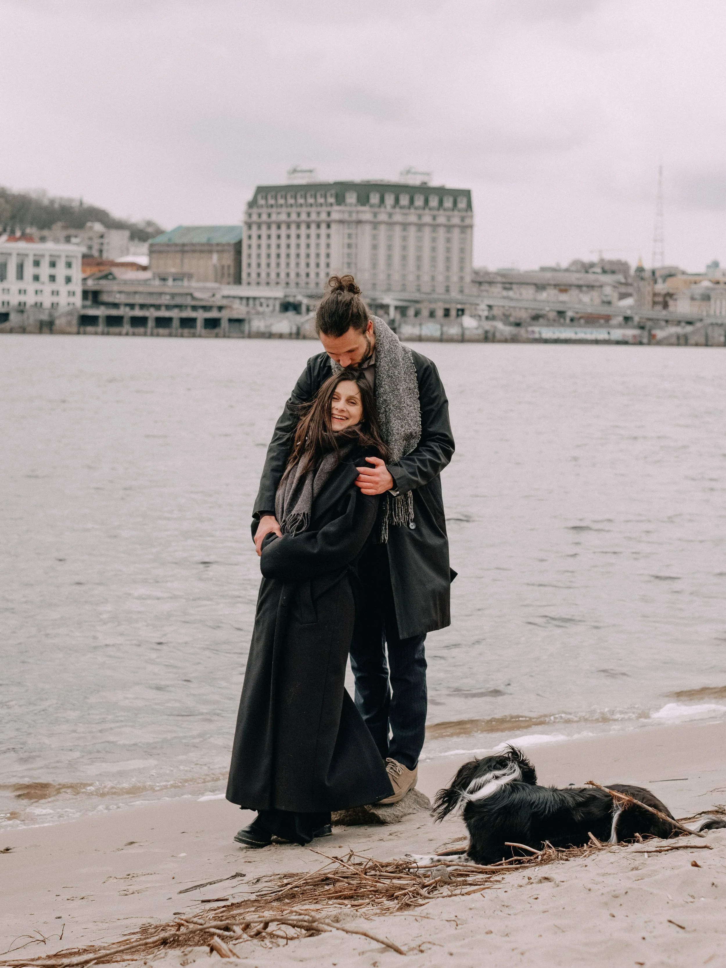 A couple with a dog.