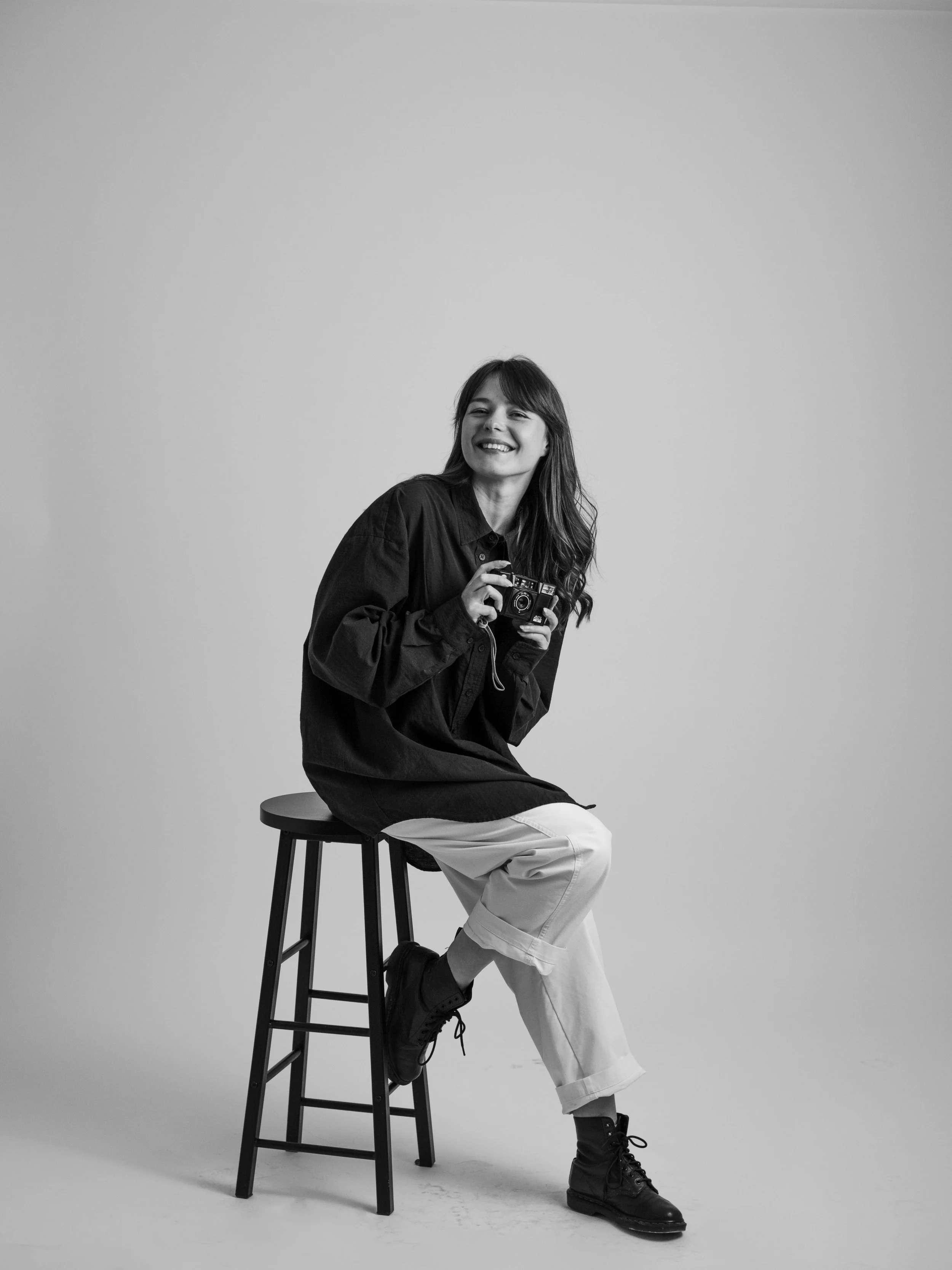 A photographer with camera in a studio