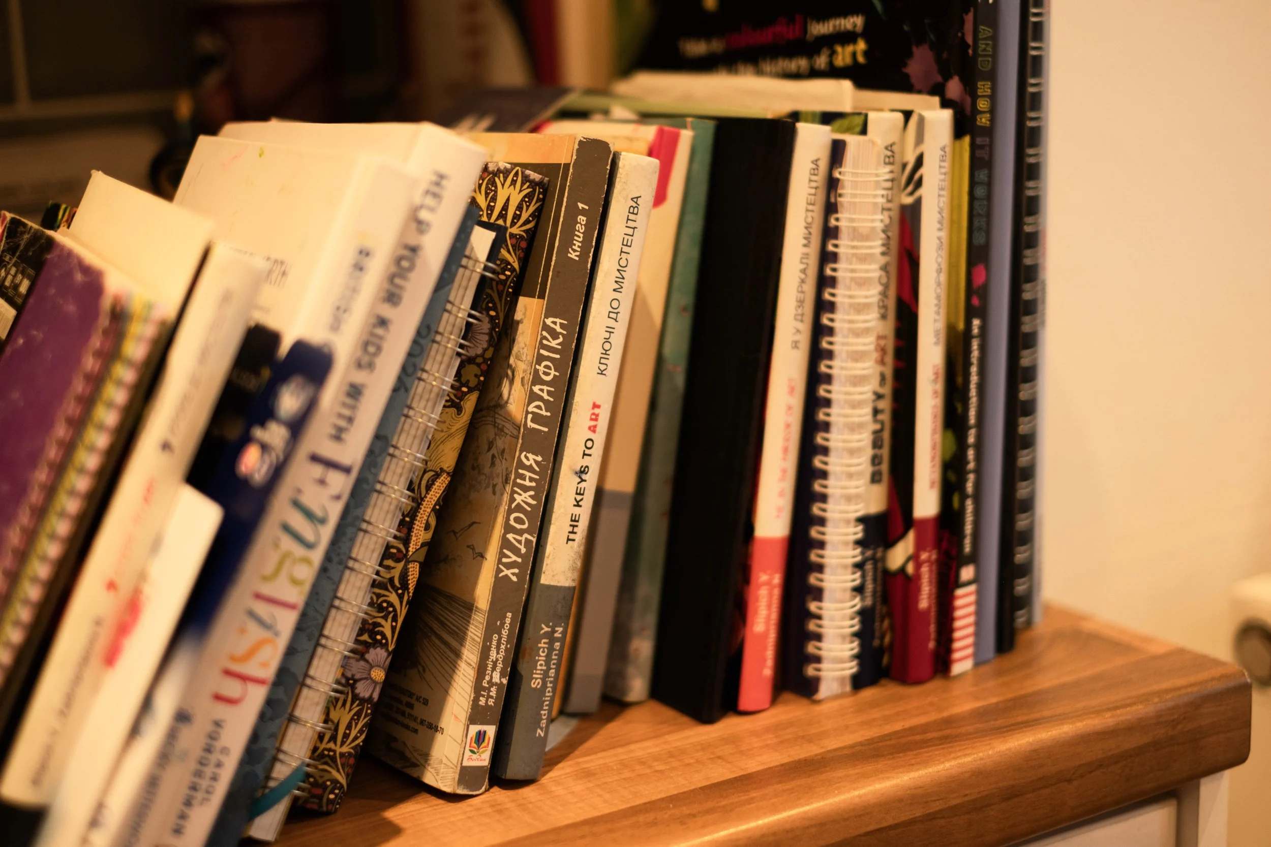Books on a wooden shelf.