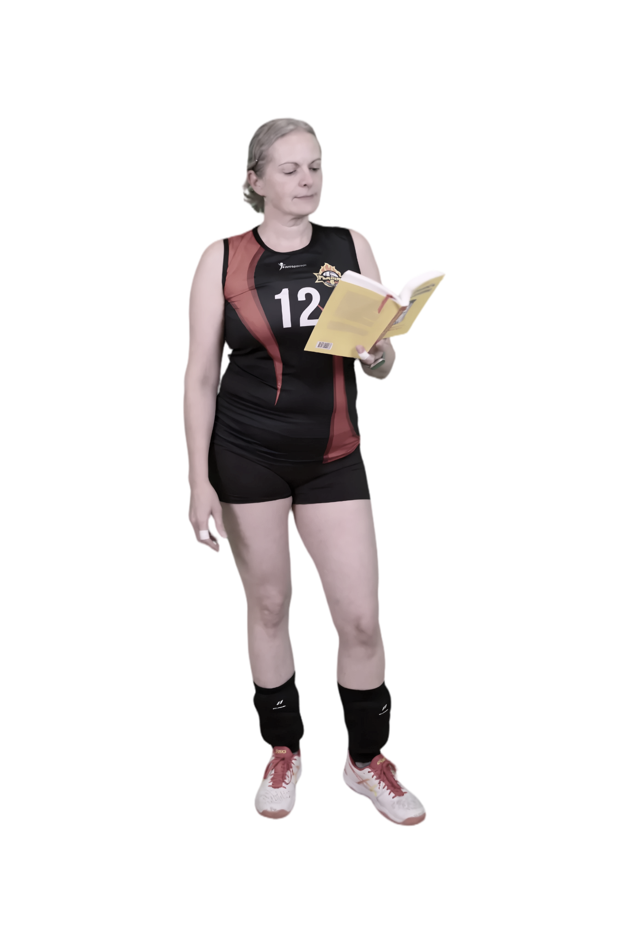 A female volleyball player in a black and red uniform reading a book.