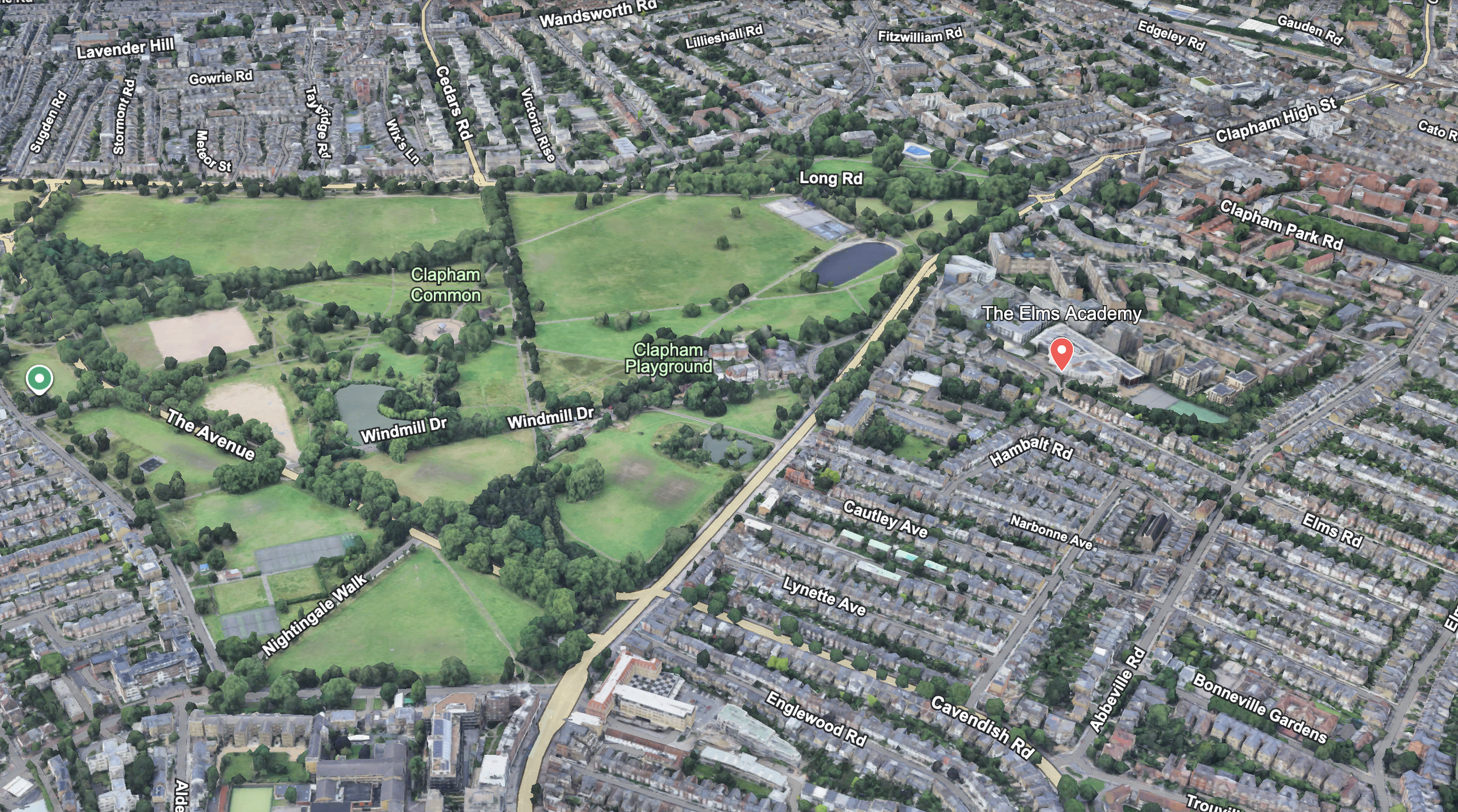 Aerial view of Clapham Common park with green fields, trees, and recreational areas, surrounded by residential neighborhoods and labeled streets in London.