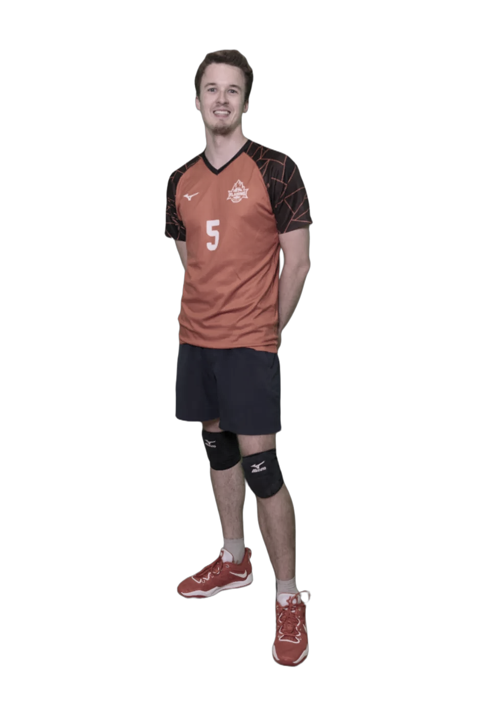A young man with short brown hair, wearing a red and black volleyball uniform with the number 5, black knee pads, red athletic shoes, and a smile, standing against a black background.