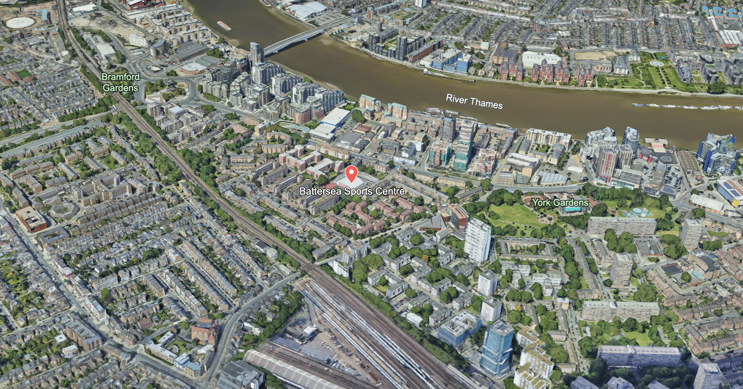 Aerial view of central London showing the River Thames, Battersea Sports Centre, York Gardens, and surrounding residential and commercial buildings.